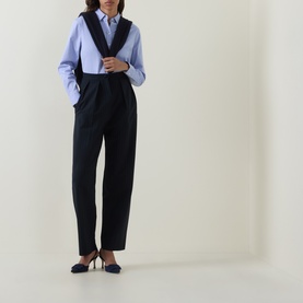Model wearing Hugo Boss light purple cotton blouse with navy waistcoat, tailored trousers and navy heels.