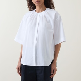 Model wearing Hugo Boss white cotton blouse with gathered neckline, short sleeves and relaxed fit, styled with dark trousers