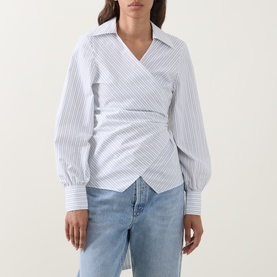 Model wearing Hugo Boss light purple striped cotton blouse with wrap front, ruched waist, and cuffed long sleeves, styled with blue jeans.