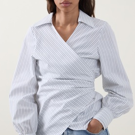 Model wearing Hugo Boss light purple striped cotton wrap blouse with V-neckline, long sleeves, and ruched waist detail
