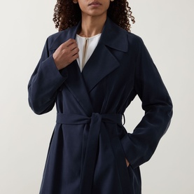 Model wearing Hugo Boss dark blue viscose wrap coat with wide lapels and self-tie belt, styled with a white top underneath