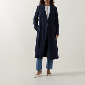 Model wearing Hugo Boss dark blue viscose trench coat, styled with white top, blue wide-leg jeans and beige heels