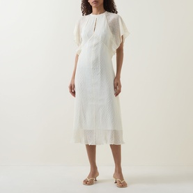 Model wearing Hugo Boss Optic Beige midi dress with flutter sleeves, keyhole neckline, and sheer pleated hem, styled with nude heeled mules.