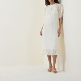 Model wearing Hugo Boss Optic Beige polyester midi dress with flutter sleeves, pleated hem, and button neckline, styled with nude strappy sandals.