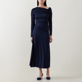 Model wearing Hugo Boss dark blue midi dress with asymmetric neckline, ruched waist, and long sleeves, styled with navy heels.