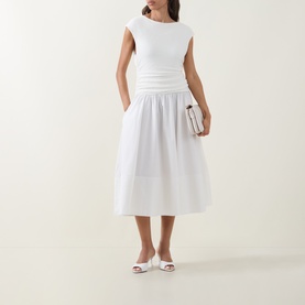 Model wearing Hugo Boss white dress with fitted ribbed top, ruched waist and full cotton midi skirt, styled with white mules and small bag