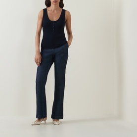 Model wearing Hugo Boss Fafflesia Rib-Knit Vest in dark blue with scoop neck and half placket, styled with navy wide-leg trousers and gold heels