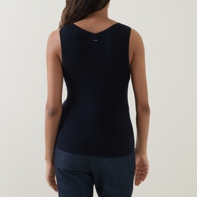 Model wearing Hugo Boss Fafflesia Rib-Knit Vest in dark blue, rear view showing scoop back and logo detail, styled with dark denim jeans