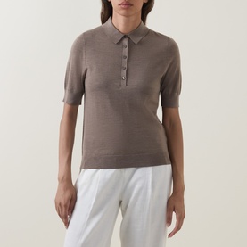 Model wearing Hugo Boss Fidenka Knitted Polo Shirt in Brown Overflow, short sleeves, polo collar, styled with white trousers