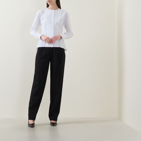 Model wearing Hugo Boss Beplum Collarless White Shirt with flared hem, styled with black wide-leg trousers and black heels.