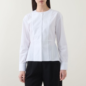 Model wearing Hugo Boss Beplum Collarless White Shirt with concealed front fastening, flared hem, and long sleeves with buttoned cuffs