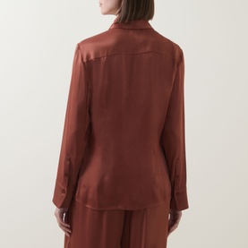 Model wearing Hugo Boss rust/copper satin viscose shirt, rear view, paired with matching wide-leg trousers