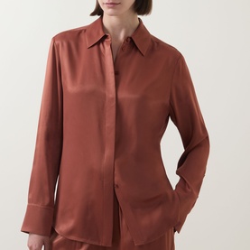 Model wearing Hugo Boss rust copper satin-finish viscose shirt with pointed collar, concealed placket and long sleeves