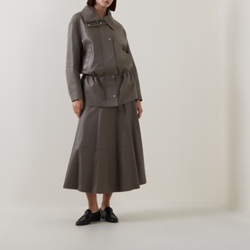 Model wearing Hugo Boss Brown Overflow leather midi skirt with matching jacket and black loafers