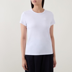 Model wearing Hugo Boss white short-sleeve T-shirt with subtle chest logo, styled with dark wide-leg trousers.