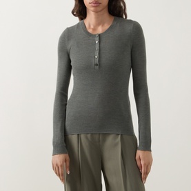 Model wearing Hugo Boss dark green ribbed wool henley top with long sleeves and button placket, styled with khaki wide-leg trousers