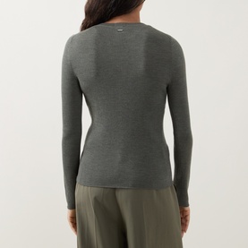 Model wearing Hugo Boss dark green long-sleeve ribbed wool top, styled with khaki wide-leg trousers, rear view.