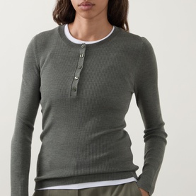 Model wearing Hugo Boss dark green ribbed wool henley top with button placket, layered over white crew neck top