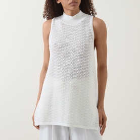 Model wearing Hugo Boss Open White sleeveless cotton crochet-knit top with mock neck, styled over a white skirt.