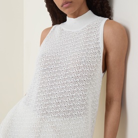 Model wearing Hugo Boss Open White sleeveless cotton crochet-knit top with mock-neck collar, close-up torso shot