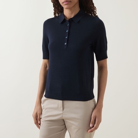 Model wearing Hugo Boss dark blue short-sleeve wool polo top with collar and button placket, styled with beige trousers.