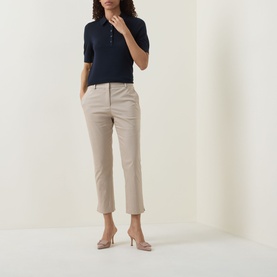 Model wearing Hugo Boss dark blue short-sleeve wool polo top with button placket, styled with beige tapered trousers and nude heels.