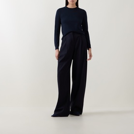 Model wearing Hugo Boss dark blue fine knit wool top with wide-leg navy trousers, crew neck and long sleeves.