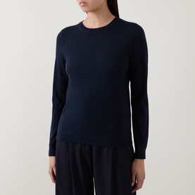 Model wearing Hugo Boss dark blue wool crew neck jumper with long sleeves, styled with wide-leg black trousers.