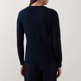 Model wearing Hugo Boss dark blue 100% virgin wool crew neck jumper, rear view showing long sleeves and clean finish.
