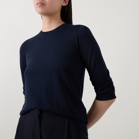 Model wearing Hugo Boss dark blue fine-knit wool crew-neck top with three-quarter sleeves, styled with black wide-leg trousers