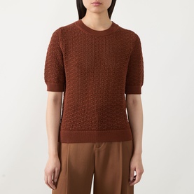 Model wearing Hugo Boss rust/copper cotton crochet-knit short-sleeve top, styled with tan wide-leg trousers