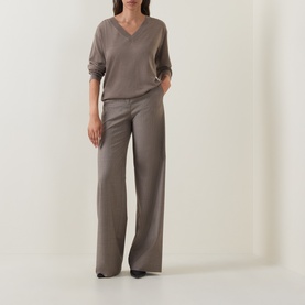 Model wearing Hugo Boss Brown Overflow wool V-neck top, styled with wide-leg trousers and black heels.