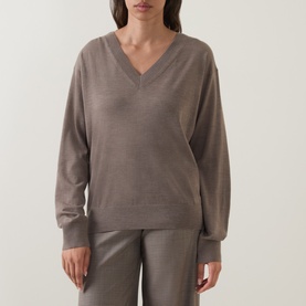 Model wearing Hugo Boss Brown Overflow virgin wool V-neck jumper, styled with matching taupe wide-leg trousers