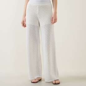 Model wearing Hugo Boss Fangrove Knitted Wide-Leg Trousers in Open White, textured knit, high-rise, wide-leg, styled with tan flat sandals