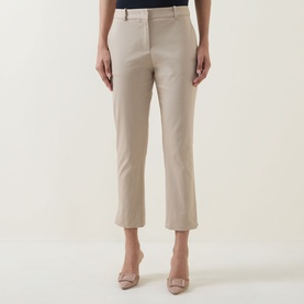 Model wearing Hugo Boss Beige Overflow slim-leg cropped trousers in cotton blend, styled with matching beige heels.