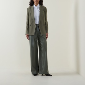 Model wearing Hugo Boss dark green wide-leg trousers in 100% polyester, styled with a matching blazer and white shirt.