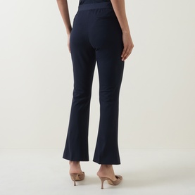 Model wearing Hugo Boss Talia-Crop1 Mid-Rise Flared Trousers in dark blue with pressed creases and flared cut, styled with nude heels