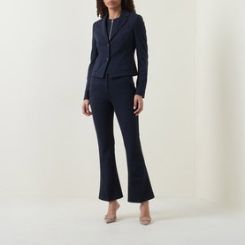 Model wearing Hugo Boss Talia-Crop1 Mid-Rise Flared Trousers in dark blue, styled with matching navy blazer and nude heels.