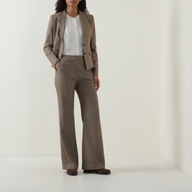 Model wearing Hugo Boss Brown Overflow wide-leg trousers, styled with a white top and taupe blazer.