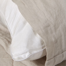 Foxford beige linen pillowcase with white pillow insert visible, soft textured fabric detail in neutral tones