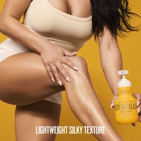 Model applying Sol De Janeiro body lotion to legs, yellow pump bottle visible, text reads Lightweight Silky Texture