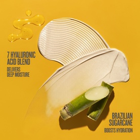 Sol De Janeiro body cream texture swatch on golden background with sugarcane and text highlighting 7 hyaluronic acid blend and Brazilian sugarcane