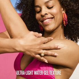 Model applying Sol De Janeiro ultra-light water-gel body lotion to arm, text overlay reads "Ultra-Light Water-Gel Texture