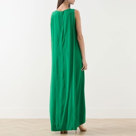 Model wearing Staud dress in Kelly green, back view, sleeveless silk maxi length with relaxed drape and column silhouette