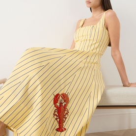 Model wearing Staud dress in Monday Stripe Lobster, yellow pinstripe midi with red lobster embroidery and square neckline with thin straps.