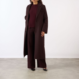 Model wearing Victoria Beckham Single-Breasted Coat in Acai, styled with matching wide-leg trousers and a ribbed knit top.