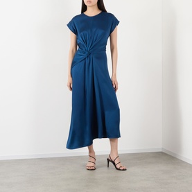 Model wearing Victoria Beckham Aria Twist Waist Dress in Dark Ocean, midi length with twist waist detail and asymmetric hem, styled with black heeled