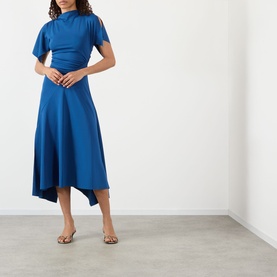 Model wearing Victoria Beckham Gathered Asymmetric Dress in Dark Ocean with high slash neck, short sleeves, and asymmetric midi skirt, styled with