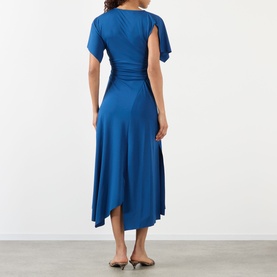 Model wearing Victoria Beckham Gathered Asymmetric Dress in Dark Ocean, back view showing short sleeves, gathered waist and asymmetric midi hem