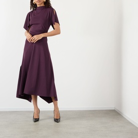 Model wearing Victoria Beckham Gathered Asymmetric Dress in Blackcurrant with high neckline, short sleeves and asymmetric midi hem, styled with black